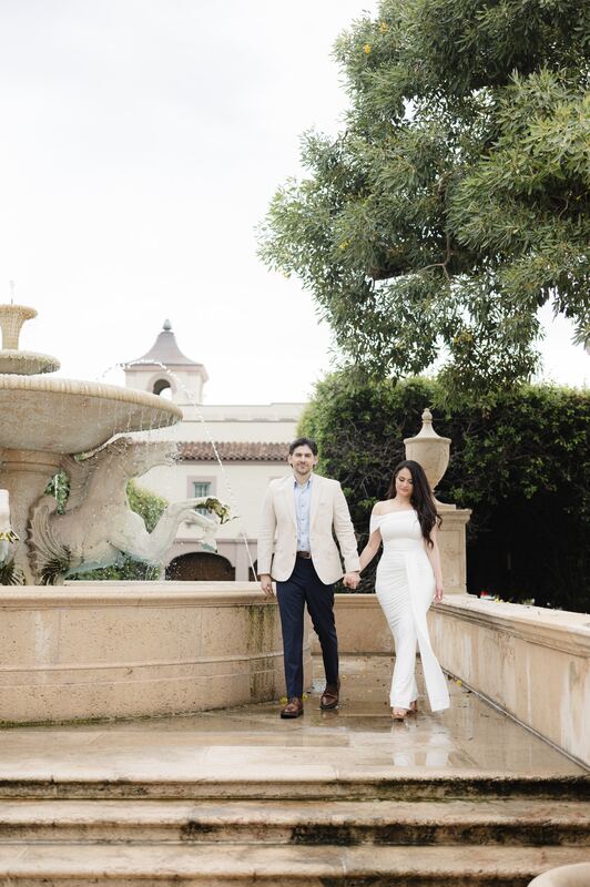 Iviani and Joey holding hands on the steps of the fountain