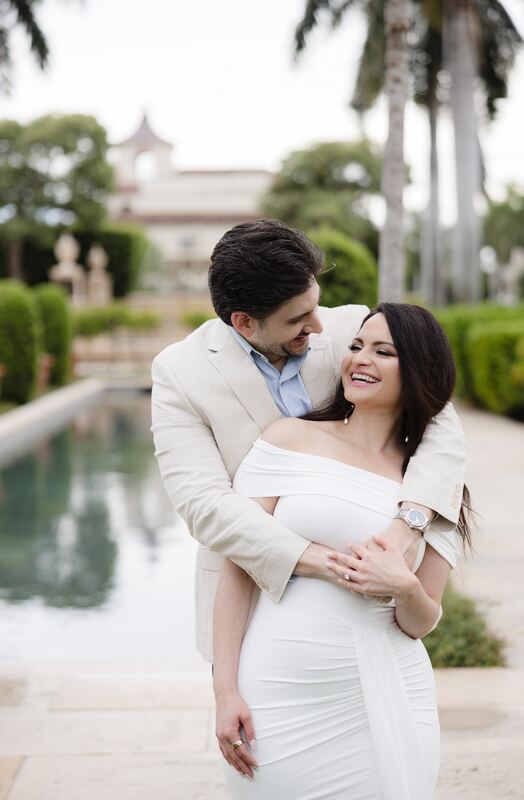 Iviani laughing in Joey&rsquo;s arms by the reflecting pool