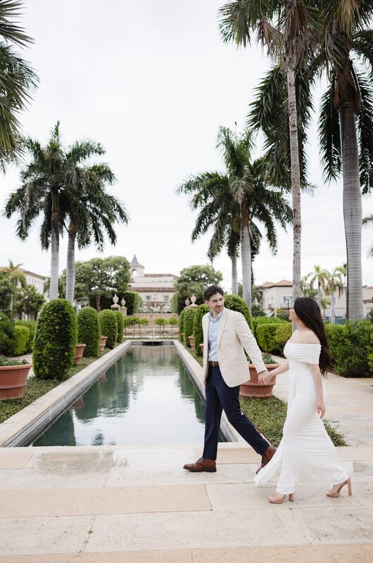 Iviani twirling her gown as she walks with Joey beside the pool