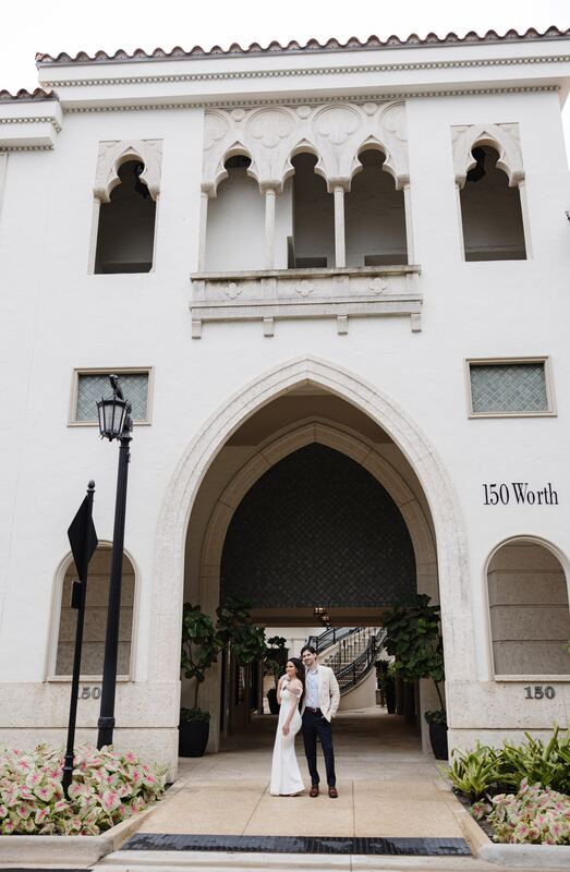 Iviani and Joey beneath a Moorish arch on Worth Avenue