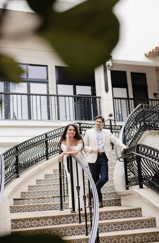 Iviani and Joey on a curved wrought-iron staircase