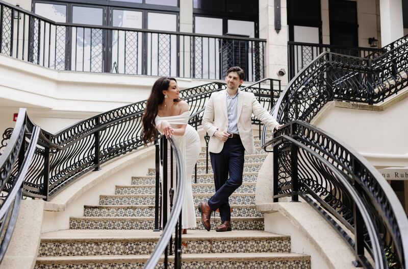 Iviani and Joey descending the staircase together