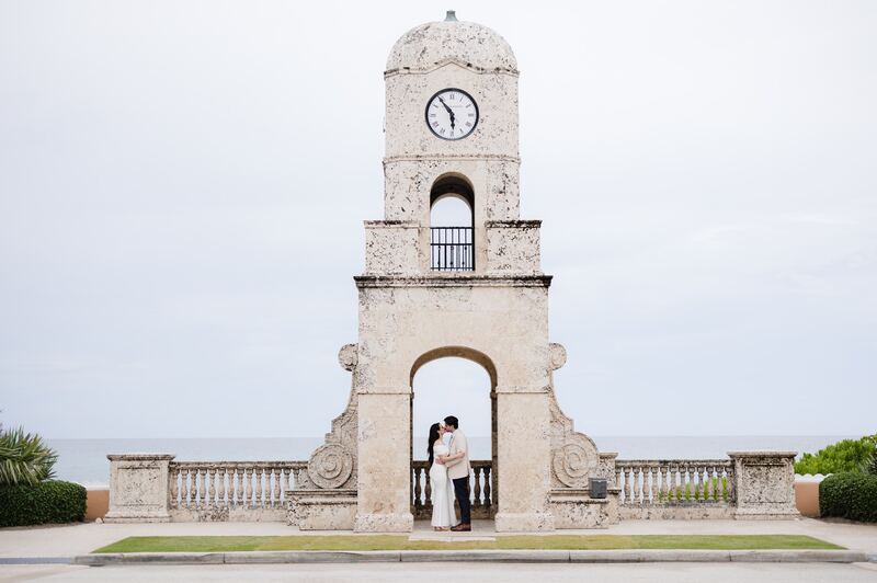 Iviani and Joey kissing beneath the clock tower