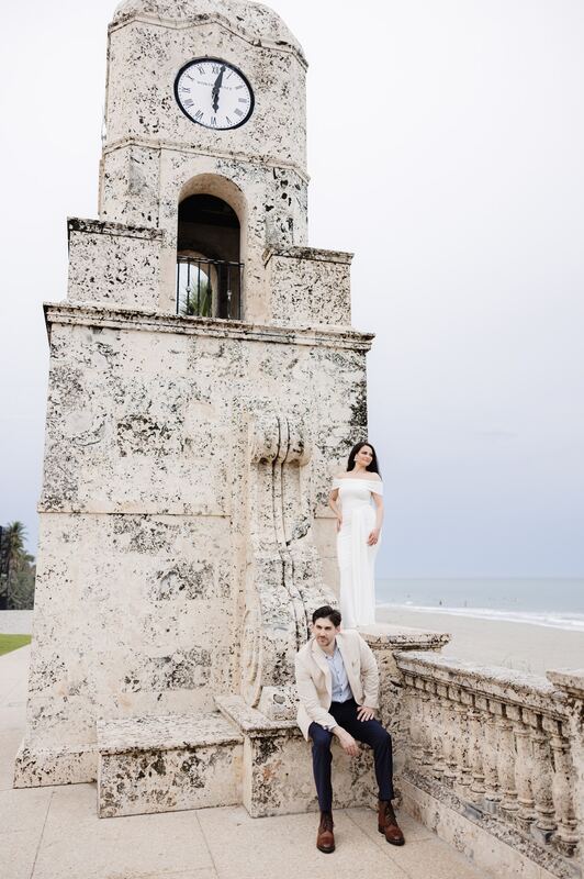 Iviani standing at the base of the clock tower with Joey seated beside her